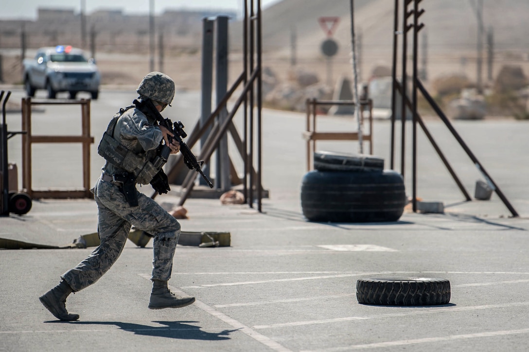 An airman runs across a parking lot during a terrorism exercise.