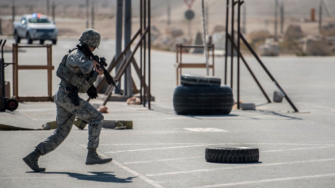 An airman runs across a parking lot during a terrorism exercise.