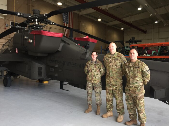 Army Pfc. Ashley Goss of Navarre, Fla.; Chief Warrant Officer 3 Tyson Edkin of Kansas City, Mo.; and Staff Sgt. Aaron Dunn of Long Beach, Calif.; with the 4-6 Attack Cavalry Squadron, 16th Combat Aviation Brigade are seen in front of an AH-64 Apache attack helicopter, at the squadron’s hangar at Joint Base Lewis-McChord, Washington, Nov. 14, 2017. DoD photo by Lisa Ferdinando