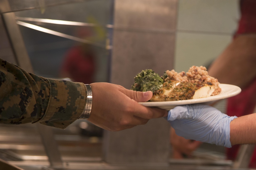 CAMP FOSTER, OKINAWA, Japan – A Marine is given their meal Nov. 15 at Mess Hall 488 aboard Camp Foster, Okinawa, Japan.