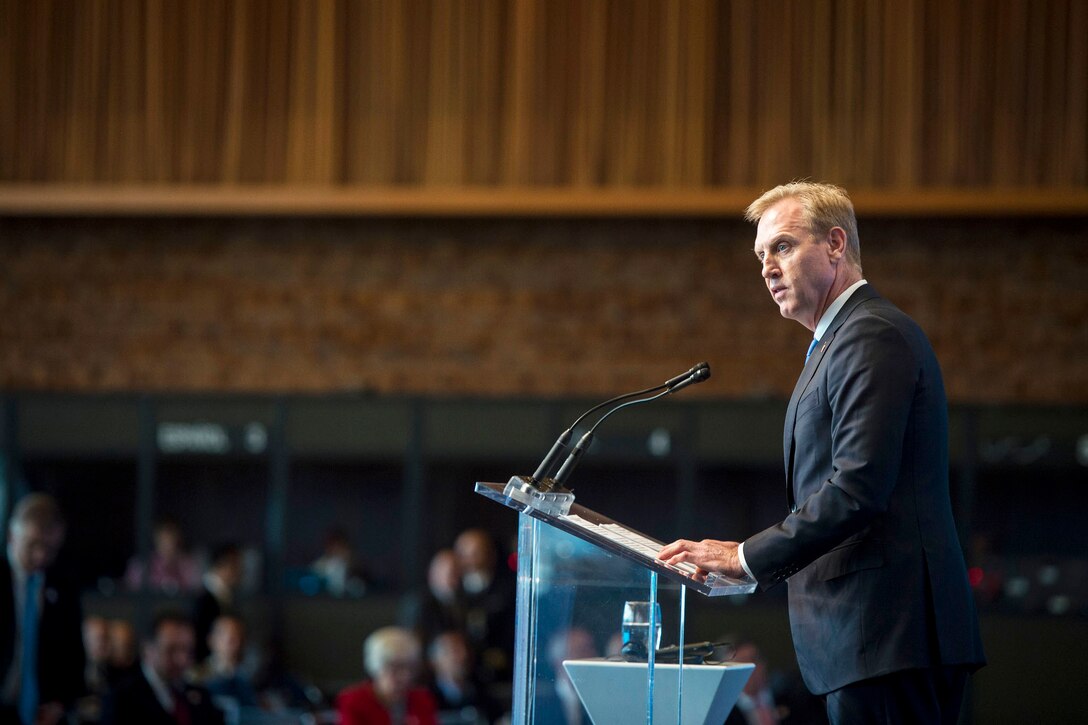 Deputy Defense Secretary Pat Shanahan speaks at a podium.