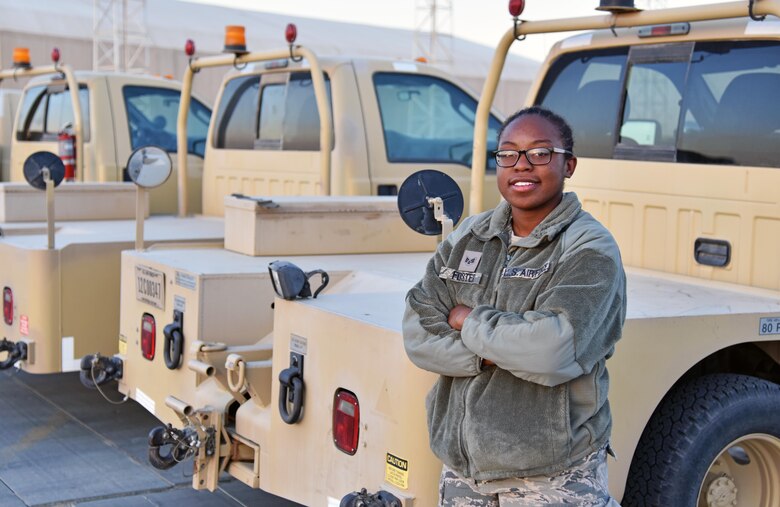 U.S. Air Force Senior Airman Sydney Foster, 100th Expeditionary Fighter Squadron munitions transporter, stands next to a truck at the 407th Air Expeditionary Group in Southwest Asia Nov. 14, 2017. Foster transports munition to the F-16 Fighting Falcons the 100th EFS flies. (U.S. Air Force photo by Staff Sgt. Joshua Edwards/Released)