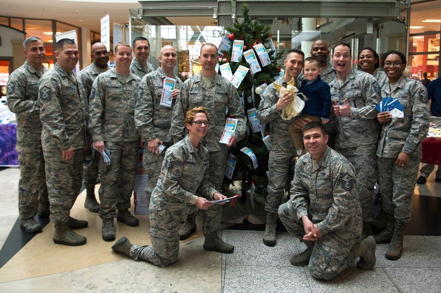 First Sergeants with the Kaiserslautern Military Community First Sergeant’s Council pose for a photo in front of the Angel Tree at Ramstein Air Base, Germany, Nov. 14, 2017. The Angel Tree is an event where members can give monetary donations to families in need in the KMC. In 2016, more than 230 families and 400 children benefitted from the event. (U.S. Air Force photo by Airman 1st Class Devin M. Rumbaugh)