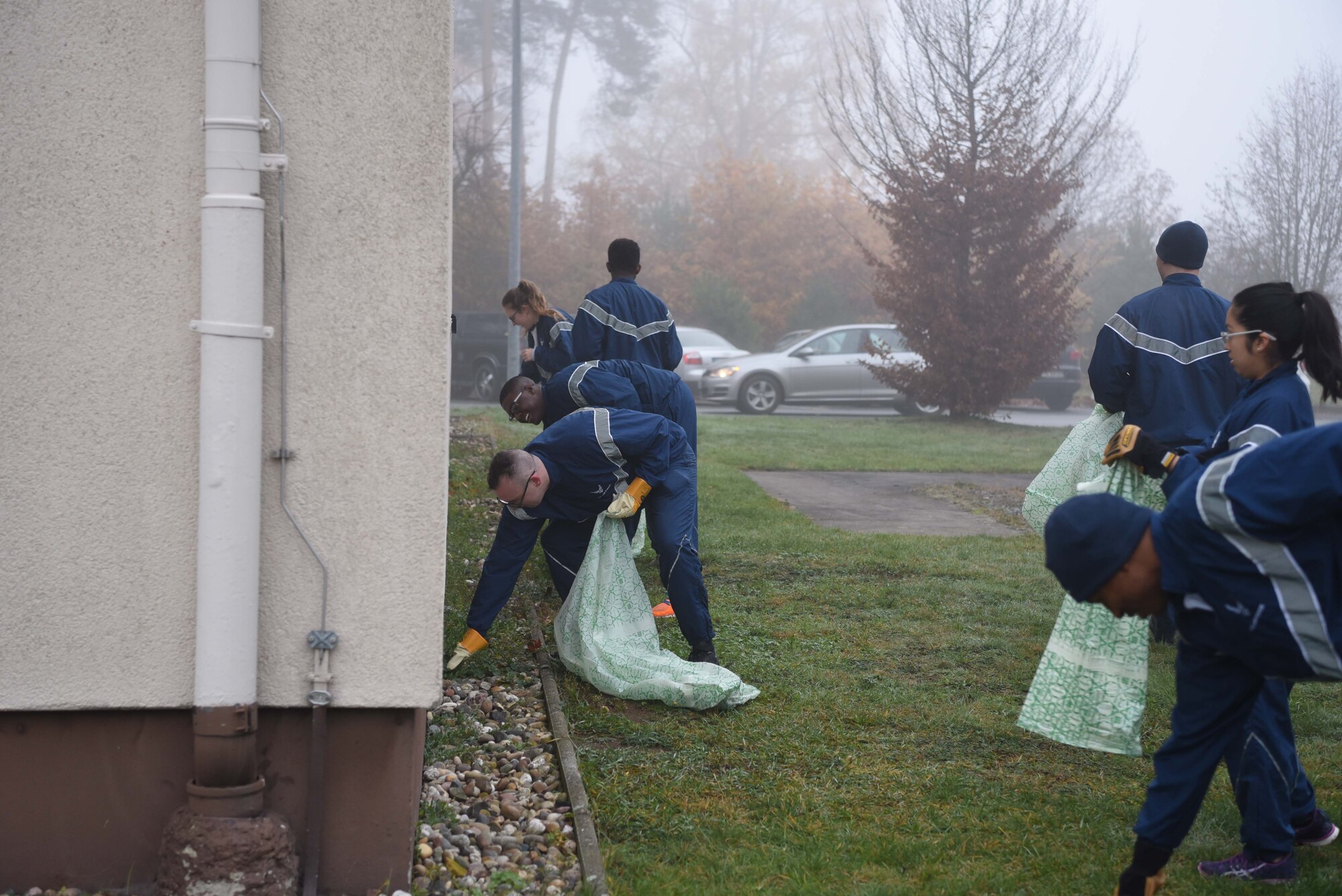 U.S. Airmen pick weeds and pick up trash from around the dorms on Ramstein Air Base, Nov. 15, 2017. Airman were broken in to small groups and assigned specific areas to clean.