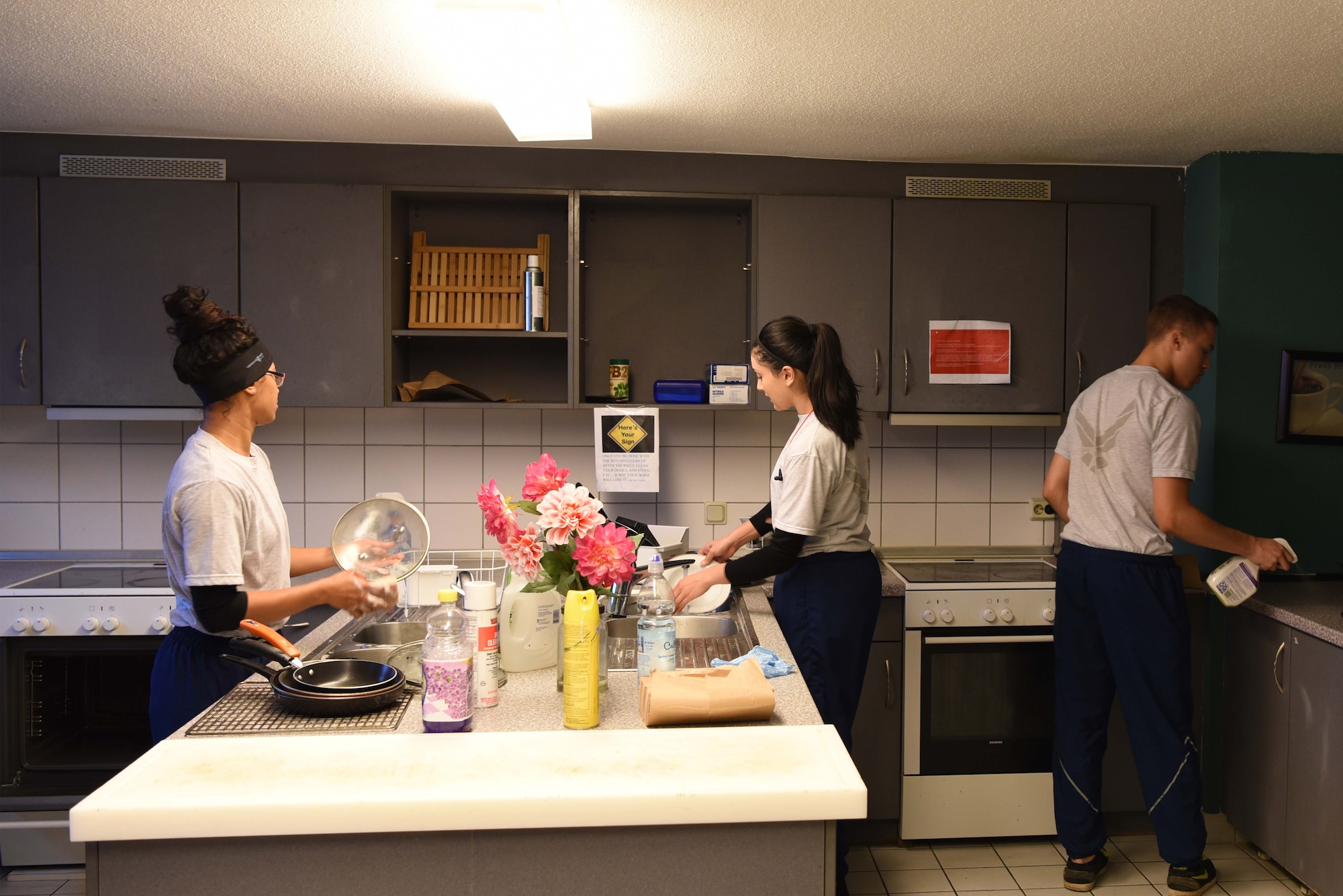 U.S. Airmen clean the kitchen in a Dormitory as part of the Base Pride program on Ramstein Air Base, Nov. 15, 2017. Airmen were given time off from work to clean the common areas at the dorm where they live.