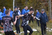 Allied Air Command inter-nation orienteering competitors pass along maps during the relay orienteering course at Brandon Country Park, England, Nov. 15. The Polish Air Force team swept all three Orienteering events in the male and female category.