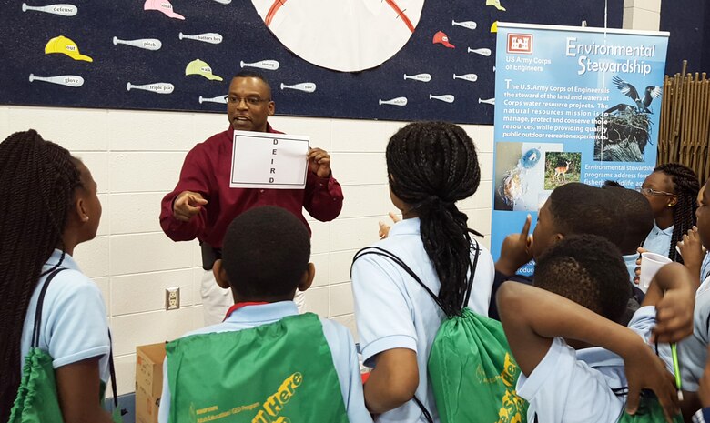 U.S. Army Corps of Engineers, Mobile District Water Management Chief James Hathorn introduces students to the fun side of math and science using a problem-solving game during a visit to a local elementary school earlier this year. Hathorn volunteers in the community regularly as a way to give back for the positive mentorship he received as a child.