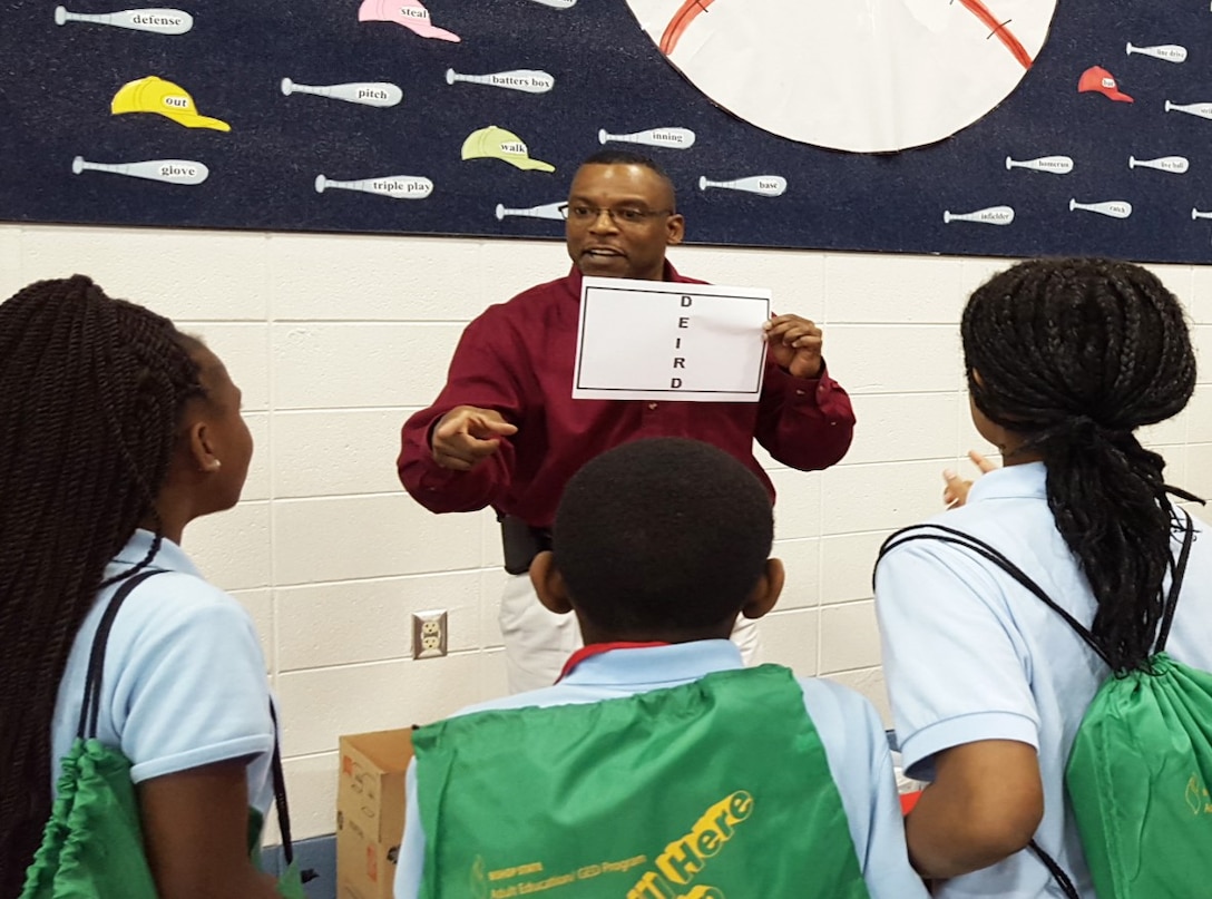 U.S. Army Corps of Engineers, Mobile District Water Management Chief James Hathorn introduces students to the fun side of math and science using a problem-solving game during a visit to a local elementary school earlier this year. Hathorn volunteers in the community regularly as a way to give back for the positive mentorship he received as a child.