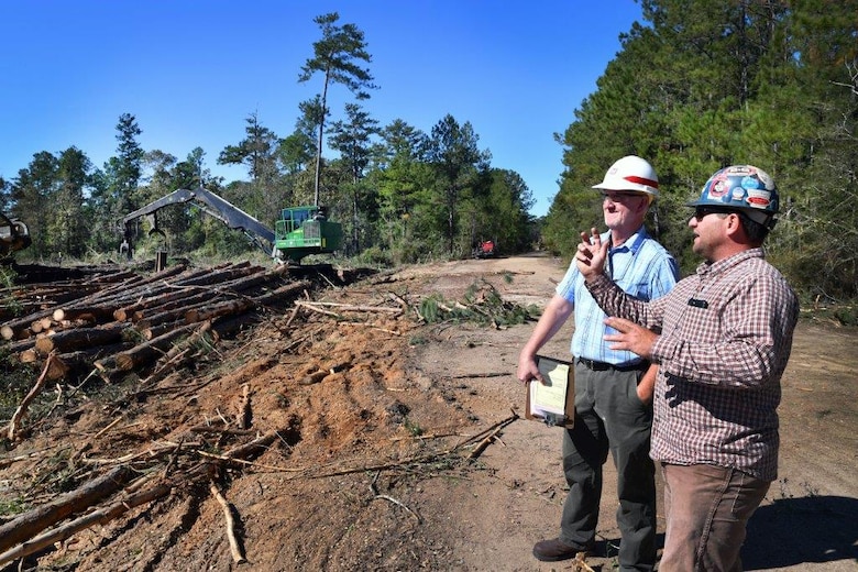 Quinn Kelly, left, and contractor Kasey Knight, discuss timber clearing operations at Stennis Space Center last week.