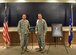 Col. Steven M. Gorski (right), commander of the Air Force Technical Applications Center, and Chief Master Sgt. Michael Joseph, AFTAC’s command chief, pose next to the plaque that officially dedicates the center’s research laboratory after former AFTAC senior scientist, Michael Harkins, at a ceremony at Cheyenne Mountain Air Force Station, Colo.  Harkins’ official portrait is on the right.  (U.S. Air Force photo by Susan A. Romano)