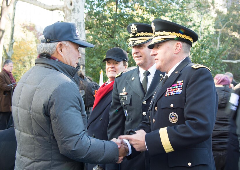(Center) Brig. Gen. Robert S. Cooley, commander of the 353d Civil Affairs Command, and (Right) Maj. Gen. Mark W. Palzer, commander of the 79th Theater Sustainment Command, talk with a veteran (Left) at the opening wreath laying ceremony of the NYC Veterans Day Parade, November 11, 2017. (U.S. Army Reserve Photo by Maj. Addie Leonhardt, 80th Training Command)