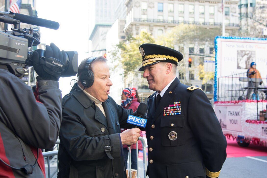 (Right) Maj. Gen. Mark W. Palzer, commander of the 79th Theater Sustainment Command, represented the U.S. Army and U.S. Army Reserve during an interview with (Center) Marvin Scott of WPIX-TV at the NYC Veterans Day Parade, November 11, 2017. (U.S. Army Reserve Photo by Maj. Addie Leonhardt, 80th Training Command)