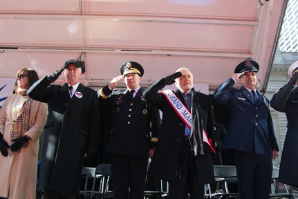 (Left to Right) Mrs. Donna Wartski; Mr. Jim Wartski; Army Reserve Maj. Gen. Mark Palzer, commander of the 79th Theater Sustainment Command; Mr. Buzz Aldrin, Grand Marshall; and Air Force Maj. Ronald Franco salute the 77th Sustainment Brigade and 80th Training Command Soldiers marching past the review stand at the NYC Veterans Day Parade, November 11, 2017. (U.S. Army Reserve Photo by Maj. Addie Leonhardt, 80th Training Command).