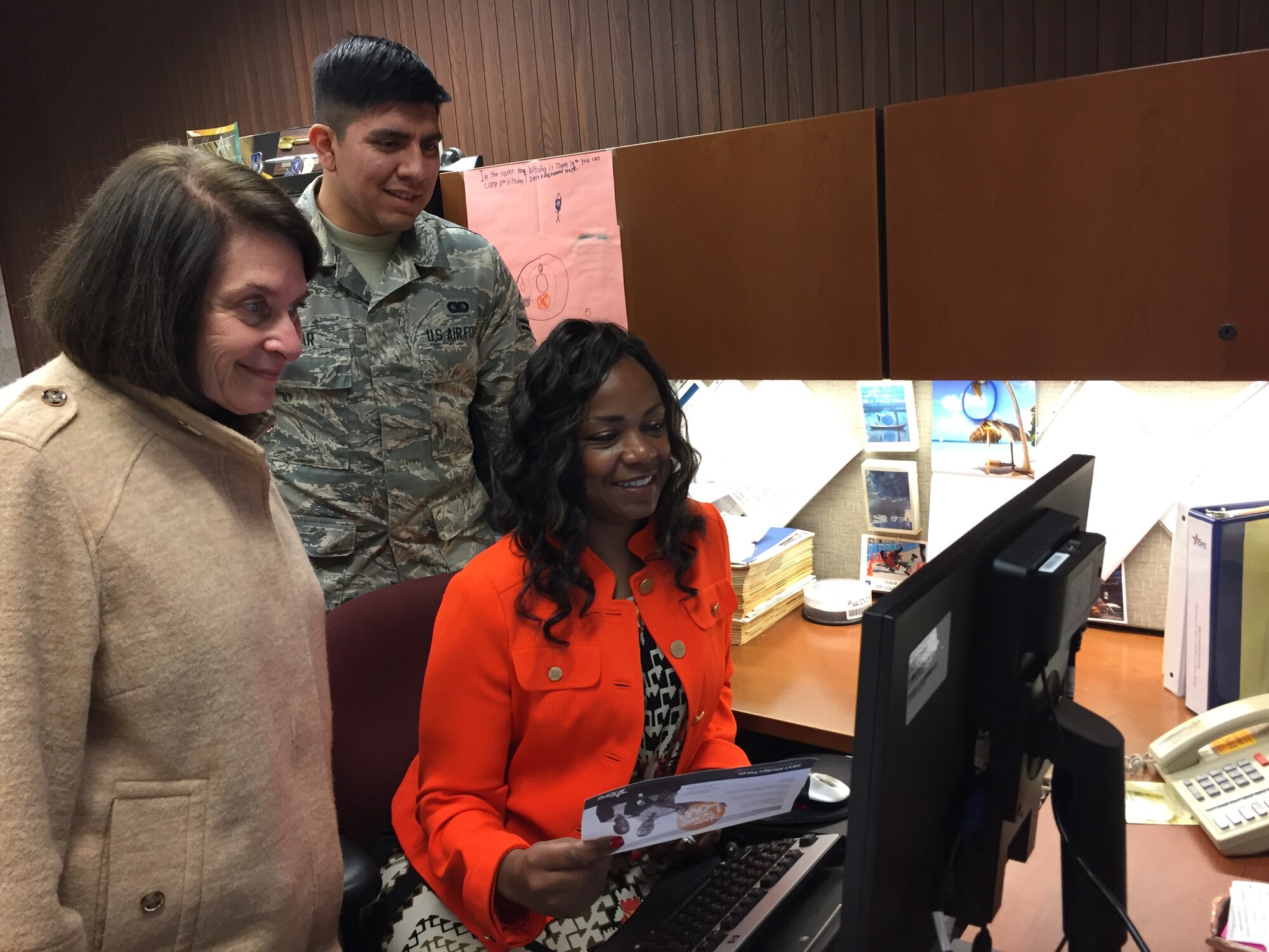 Susy Himelhoch (left), Ohio Combined Federal Campaign, Miami Valley District, volunteer executive director; Airman 1st Class JeremyTobar, CFC campaign loaned executive; and Chantaé Gray, loaned executive, review the new CFC pledge site Nov. 13. (Skywrighter photo/Amy Rollins)