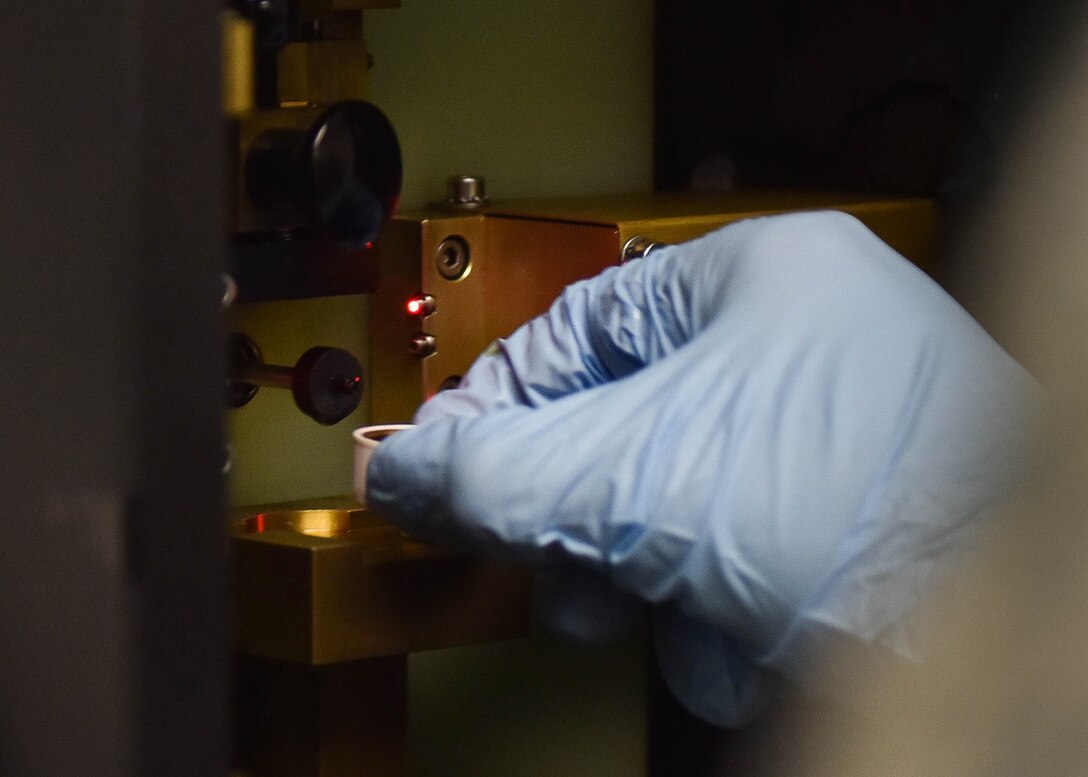 An Airman puts jet oil into an oil analyzer at Joint Base Langley-Eustis, Va., Nov. 14, 2017.