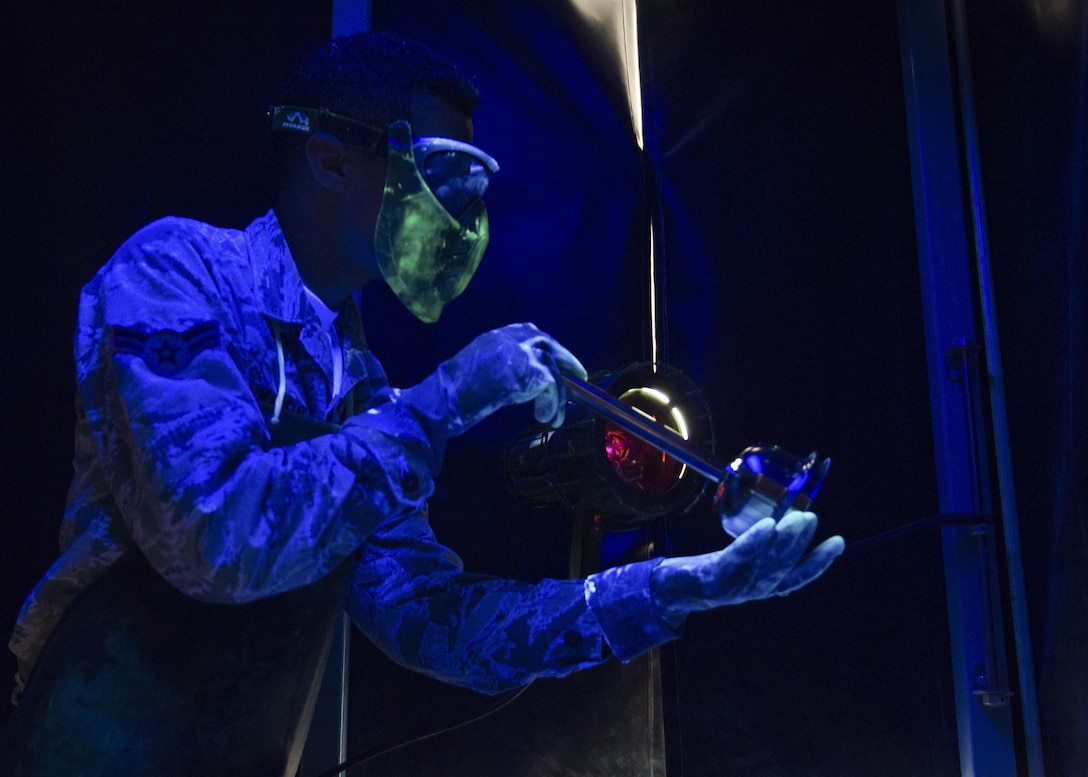 U.S. Air Force Airman 1st Class Dakota Martin, 1st Maintenance Squadron nondestructive inspection apprentice, inspects cracks under a black light at Joint Base Langley-Eustis, Va., Nov. 15, 2017.