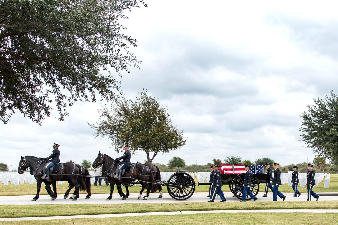A procession of soldiers on horseback and on foot escort a flag-draped coffin on a wagon.