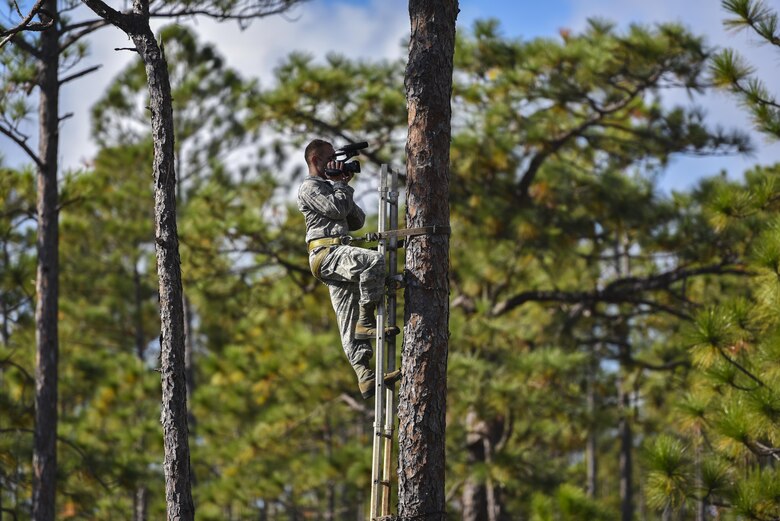 Airman 1st Class Caleb Pavao, a broadcaster with the 1st Special Operations Wing Public Affairs office, documents endangered wildlife conservation efforts at Hurlburt Field, Fla., Nov. 7, 2017. The U.S. Fish and Wildlife Service on Hurlburt Field worked with Eglin Air Force Base staff to create artificial nesting cavities in trees for the Red-cockaded Woodpecker, a process that can take one to 10 years for the bird to make. (U.S. Air Force photo by Staff Sgt. Marleah Cabano)