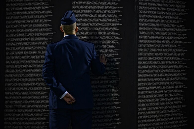 U.S. Air Force Capt. James Lanford, a 56th Fighter Wing chaplain, views and interacts with the American Veterans Traveling Tribute Wall in Buckeye, Ariz., Nov. 10, 2017. The wall is a replica of the Vietnam Veterans Memorial in Washington, D.C. and is engraved with the names of more than 58,000 service members reported killed or missing during the Vietnam War. (U.S. Air Force photo by Airman 1st Class Caleb Worpel)