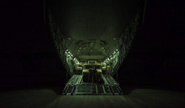 A U.S. Air Force C-17 Globemaster III aircrew from the 816th Expeditionary Airlift Squadron unloads high-mobility multipurpose vehicles during combat airlift operations at an undisclosed location, Nov. 11, 2017. The C-17 is capable of rapid strategic delivery of troops and cargo to bases throughout the U.S. Central Command area of responsibility. The aircraft can be outfitted to perform tactical airlift, airdrop, and aeromedical evacuation as missions require. (U.S. Air Force photo by Tech. Sgt. Gregory Brook)