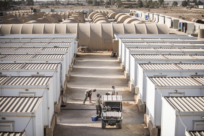 Airmen from the 332nd Expeditionary Communications Squadron dig trenches before installing copper wire as part of a base-wide wireless internet improvement project Nov. 15, 2017 in Southwest Asia. The project required numerous small trenches to be dug between housing units, allowing for the seamless installation of new infrastructure. (U.S. Air Force photo by Senior Airman Joshua Kleinholz)