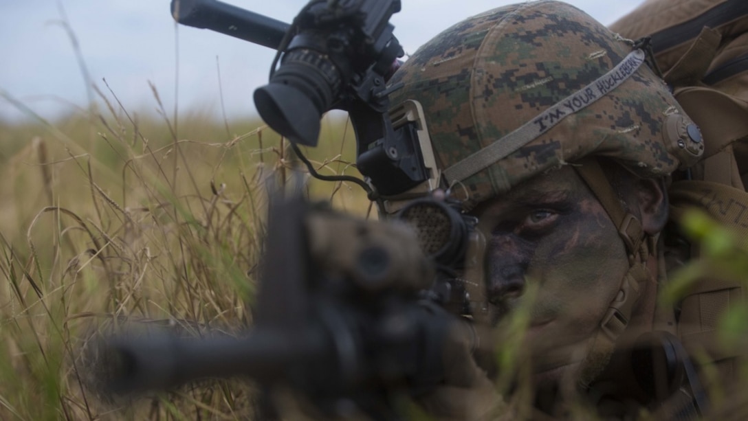 A Marine provides security while participating a simulated night raid during an air assault training event at Marine Corps Air Station Futenma, Okinawa.