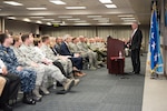 Defense Secretary Jim Mattis stands behind a podium at a town hall.