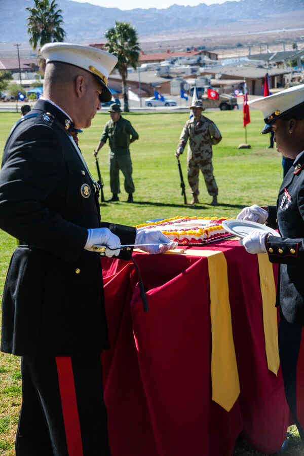 Maj. Gen. William F. Mullen III, Commanding General, Marine Air Ground Task Force Training Command, cuts the first piece of cake during the Marine Corps Birthday Pageant, at Lance Cpl. Torrey L. Gray Field aboard the Marine Corps Air Ground Combat Center, Twentynine Palms, Calif., Nov. 08, 2017. The event included a historical uniform pageant and the traditional cake cutting ceremony in honor of the Marine Corps birthday. (U.S. Marine Corps photo by Pfc. William J. Chockey III)