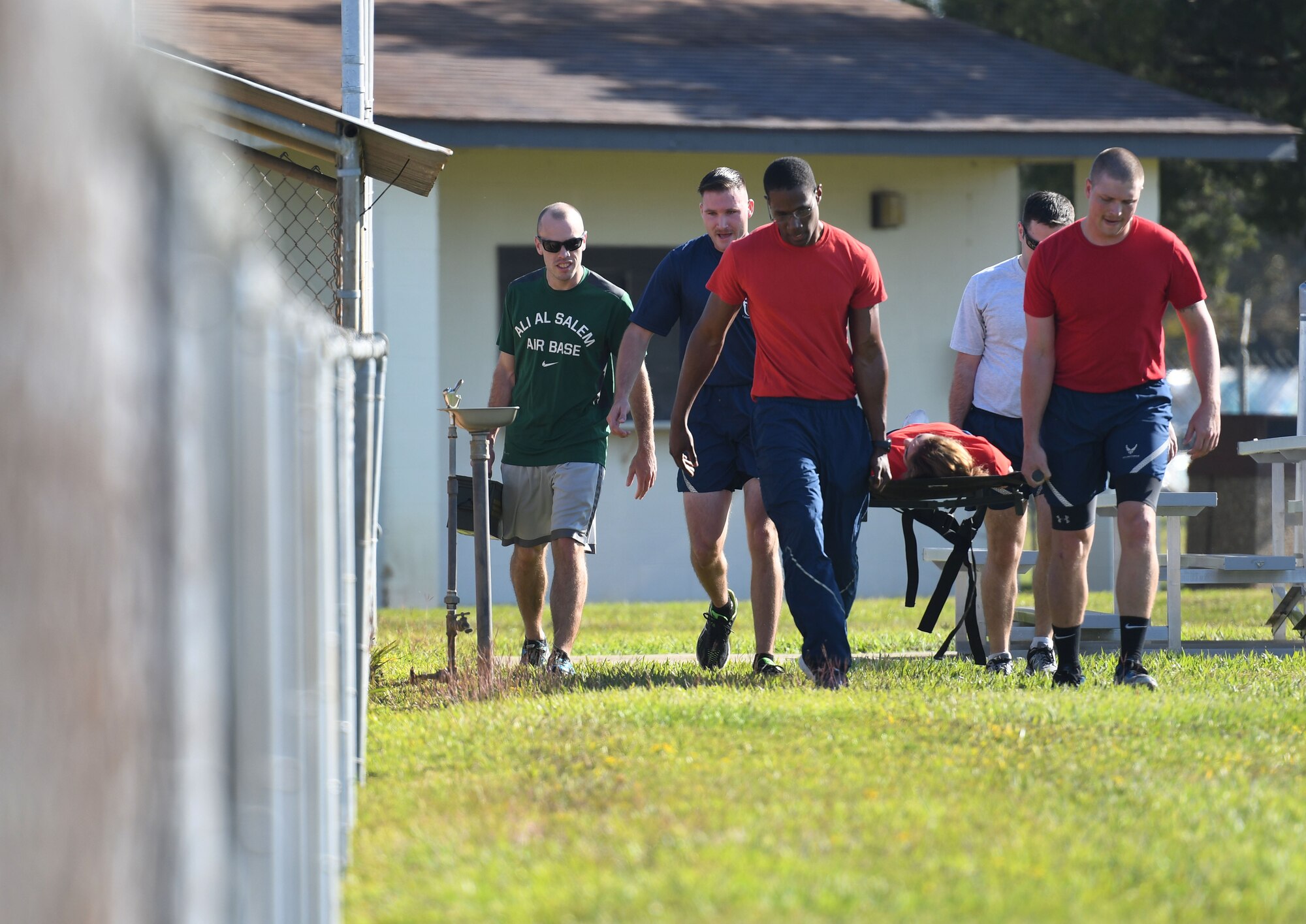 Keesler Airmen participate in a litter carry during Wingman Day Nov. 16, 2017, on Keesler Air Force Base, Mississippi. Wingman Day consisted of Keesler Airmen participating in unit-wide Comprehensive Airman Fitness courses which focused on resiliency and teambuilding initiatives across the base. (U.S. Air Force photo by Kemberly Groue)