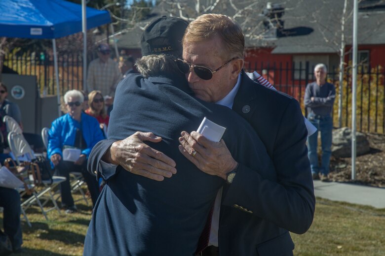 Congressman Paul Cook, Representative for California’s 8th Congressional District and a  Marine Corps veteran, embrace prior to the Veterans Day ceremony at Big Bear Lake, Calif., Nov. 11, 2017. Cook was one of four distinguished guests who spoke at the event. (U.S. Marine Corps photo by Lance Cpl. Preston L. Morris)