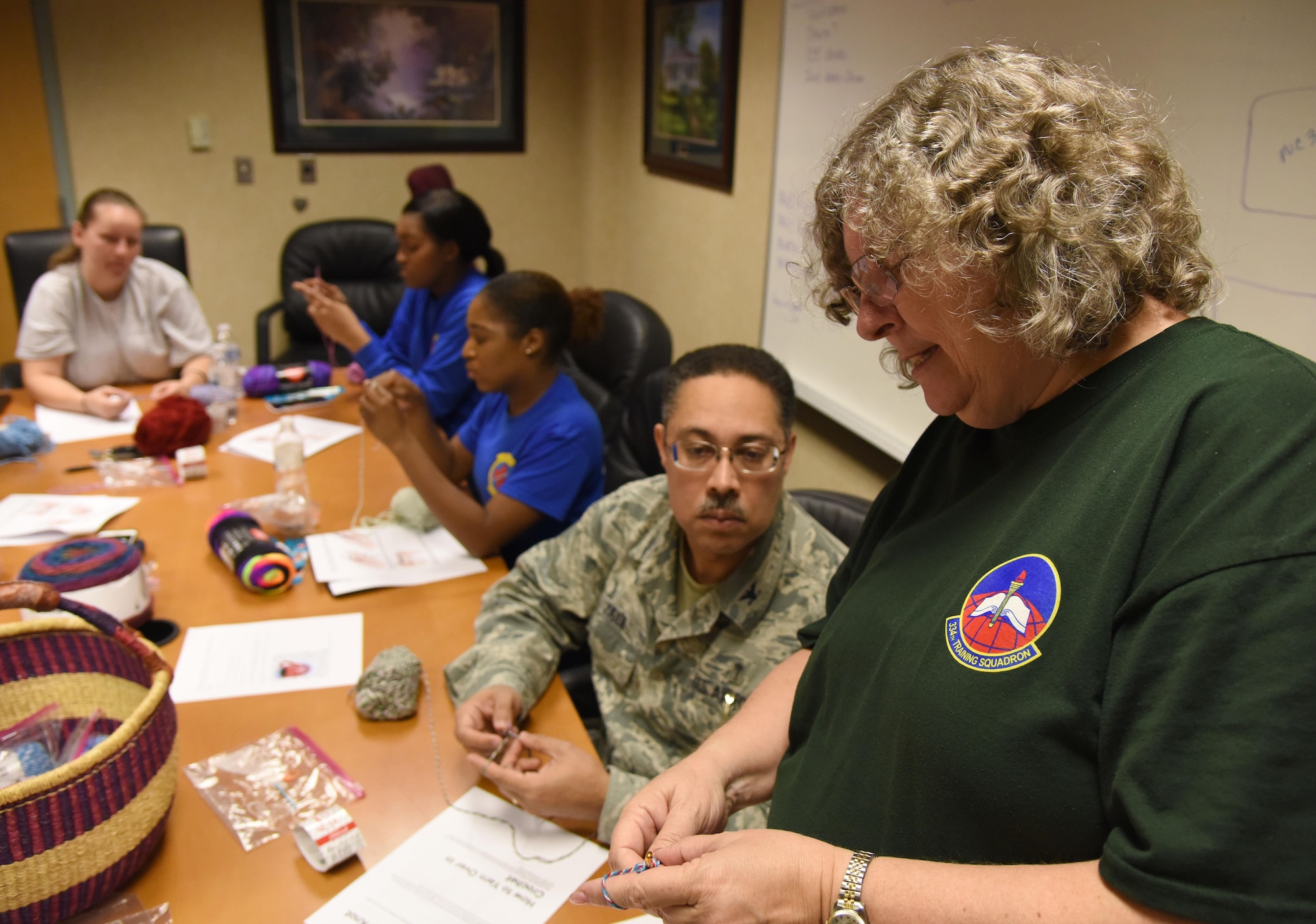 Jere Funk, 334th Training Squadron training specialist, teaches crochet techniques to Keesler Airmen during Wingman Day Nov. 16, 2017, on Keesler Air Force Base, Mississippi. Wingman Day consisted of Keesler Airmen participating in unit-wide Comprehensive Airman Fitness courses which focused on resiliency and teambuilding initiatives across the base. (U.S. Air Force photo by Kemberly Groue)