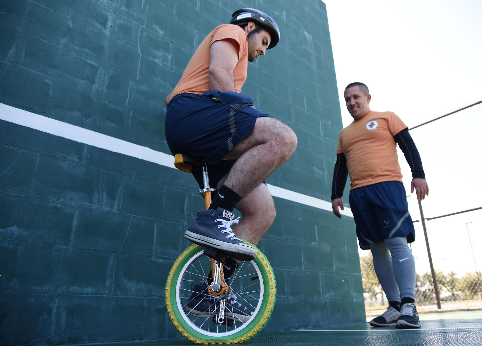 Senior Airmen Emanuel De Alba, 81st Medical Support Squadron professional contracting officer representative, and Angel Tucker, 81st MDSS medical logistics technician, participate in an unicycle training class during Wingman Day Nov. 16, 2017, on Keesler Air Force Base, Mississippi. Wingman Day consisted of Keesler Airmen participating in unit-wide Comprehensive Airman Fitness courses which focused on resiliency and teambuilding initiatives across the base. (U.S. Air Force photo by Kemberly Groue)