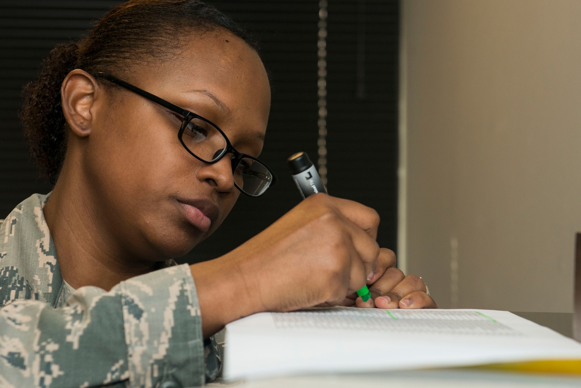 U.S. Air Force Staff Sgt. Jasmine Turner, 20th Force Support Squadron career development supervisor, highlights information while going through folders at Shaw Air Force Base, South Carolina, Nov. 13, 2017.