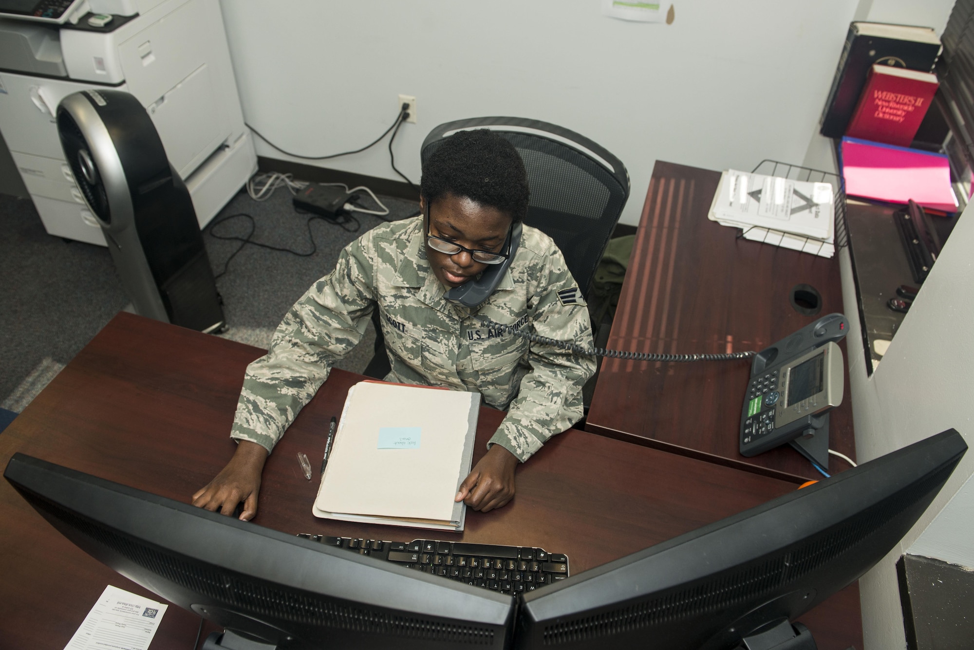 U.S. Air Force Senior Airman Brittany Scott, 20th Force Support Squadron outbound assignments personnel specialist, works with a customer over the phone at Shaw Air Force Base, South Carolina, Nov. 13, 2017.