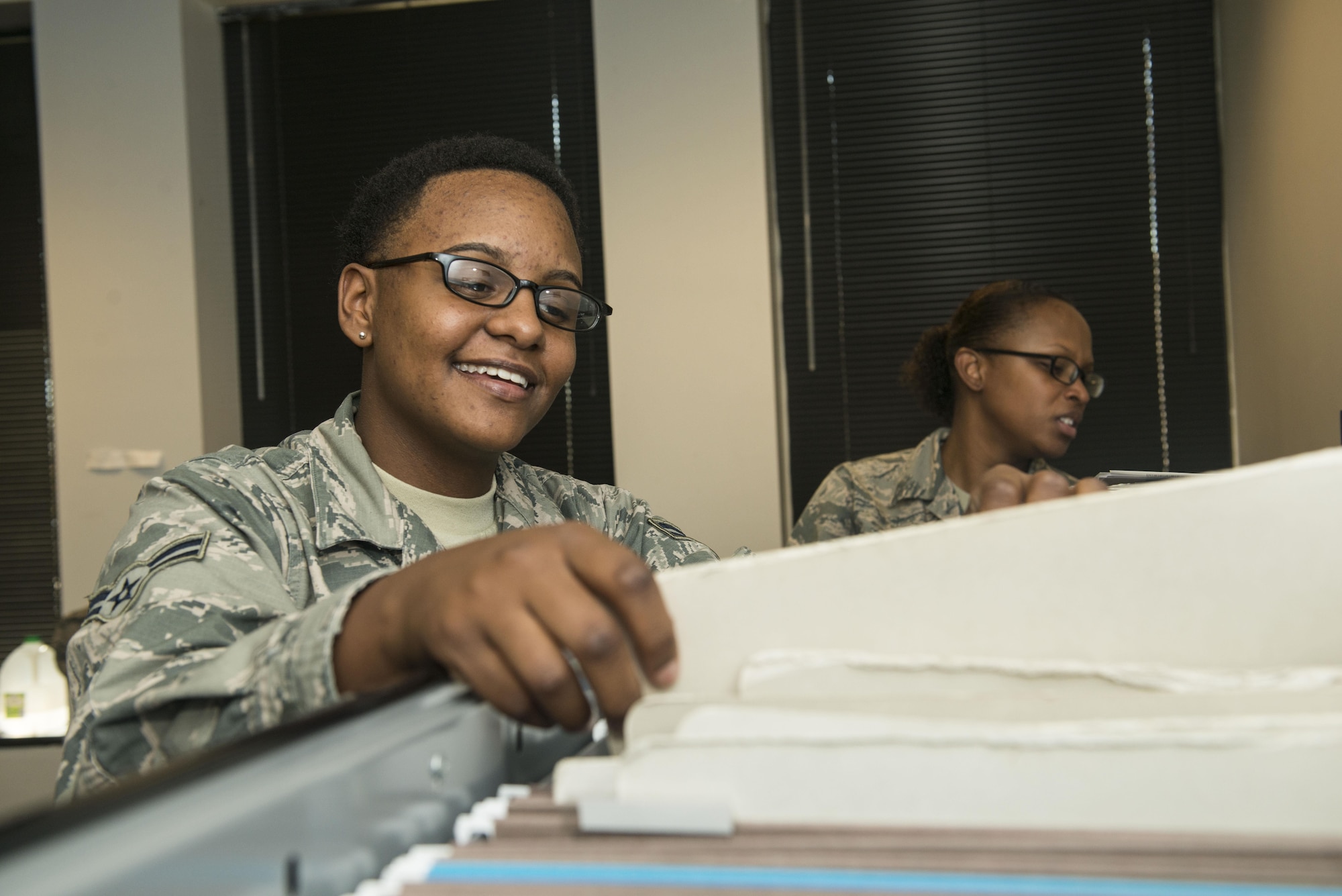 U.S. Air Force Airman 1st Class Lakeia Garner, 20th Force Support Squadron (FSS) outbound assignments personnel specialist, reviews folders while Staff Sgt. Jasmine Turner, 20th FSS career development supervisor, marks off names at Shaw Air Force Base, South Carolina, Nov. 13, 2017.