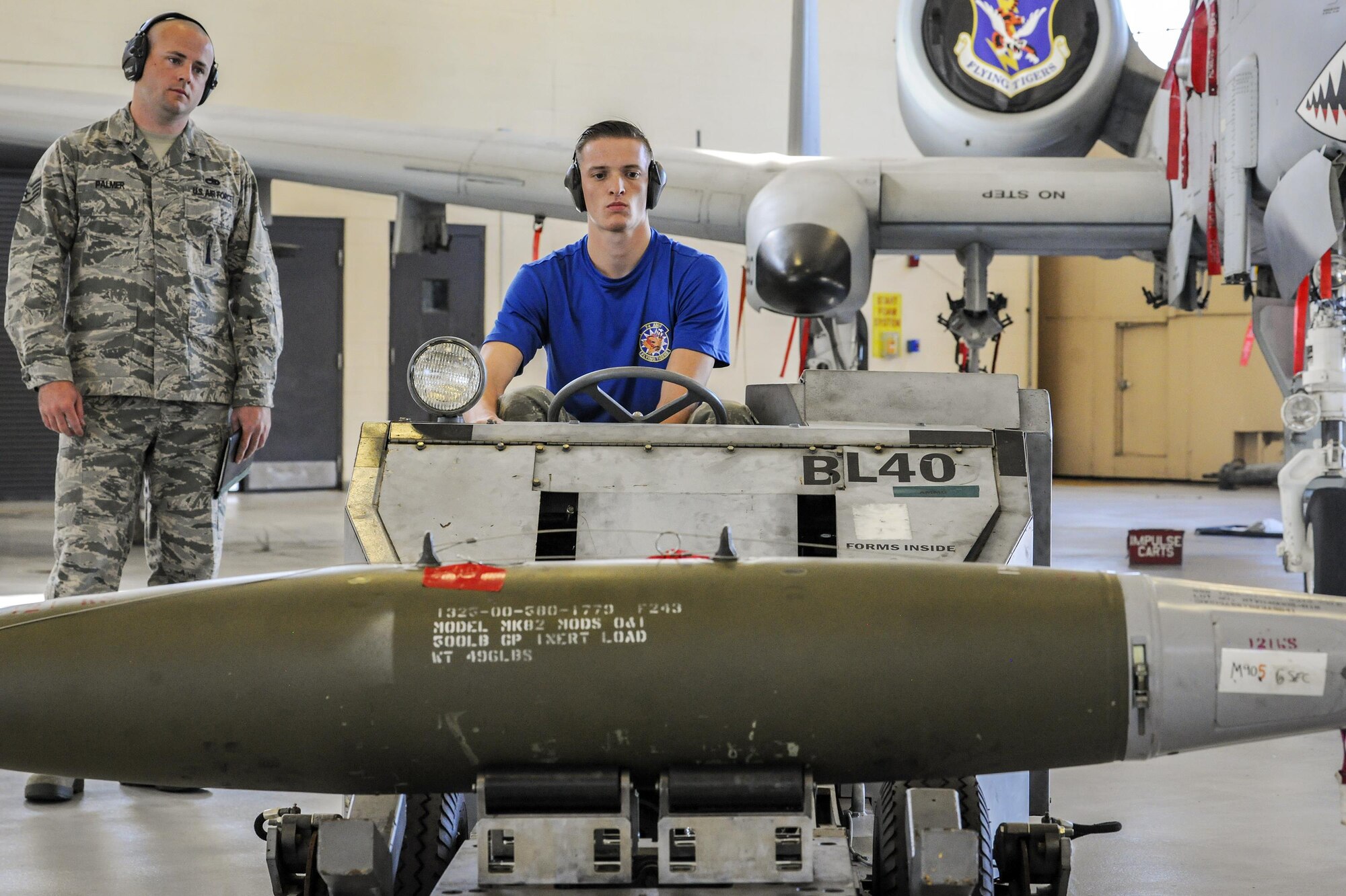 Airman 1st Class Wyatte Velasco, 74th Aircraft Maintenance Unit weapons load crew member, prepares to load a bomb during a quarterly weapons load competition, Nov. 16, 2017, at Moody Air Force Base, Ga. Judges evaluated the competitors based on dress and appearance, a knowledge exam and loading various munitions to determine the most efficient load crew. (U.S. Air Force photo by Airman Eugene Oliver)