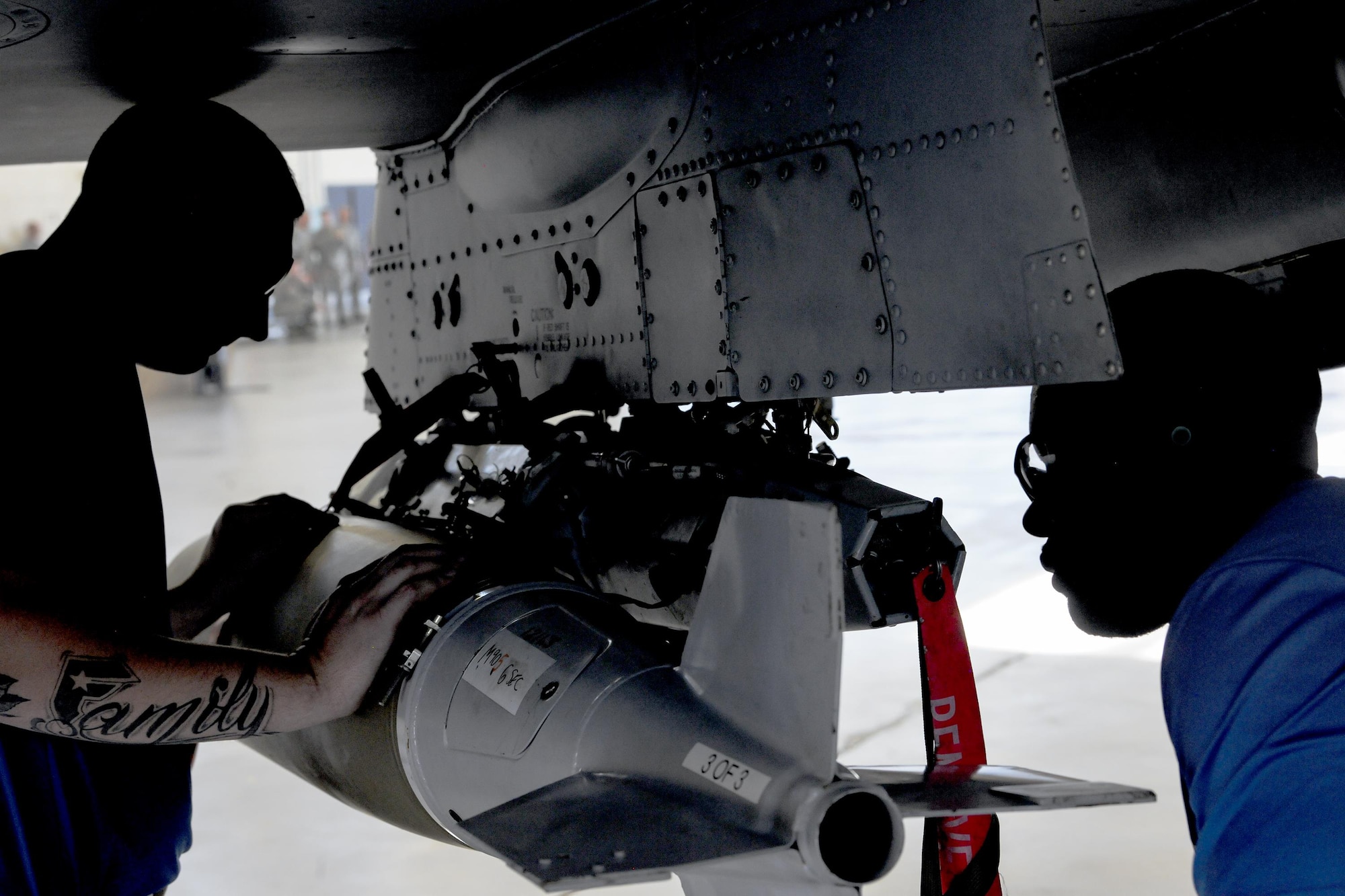 Staff Sgt. Jonathon Greg, 74th Aircraft Maintenance Unit (AMU) crew chief and Senior Airman Rodney Brown, 74th AMU load crew member, loads a MK84 bomb on an A-10C Thunderbolt II, during a quarterly weapons load competition, Nov. 16, 2017, at Moody Air Force Base, Ga. Judges evaluated the competitors based on dress and appearance, a knowledge exam and loading various munitions to determine the swiftest and most efficient load crew. (U.S. Air Force photo by Airman Eugene Oliver)