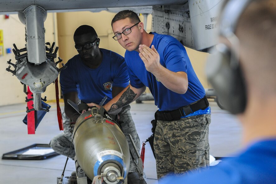 Members of the 74th Aircraft Maintenance Unit prepare to load a MK84 bomb on an A-10C Thunderbolt II, during a quarterly weapons load competition, Nov. 16, 2017, at Moody Air Force Base, Ga. Judges evaluated the competitors based on dress and appearance, a knowledge exam and loading various munitions to determine the swiftest and most efficient load crew. (U.S. Air Force photo by Airman Eugene Oliver)