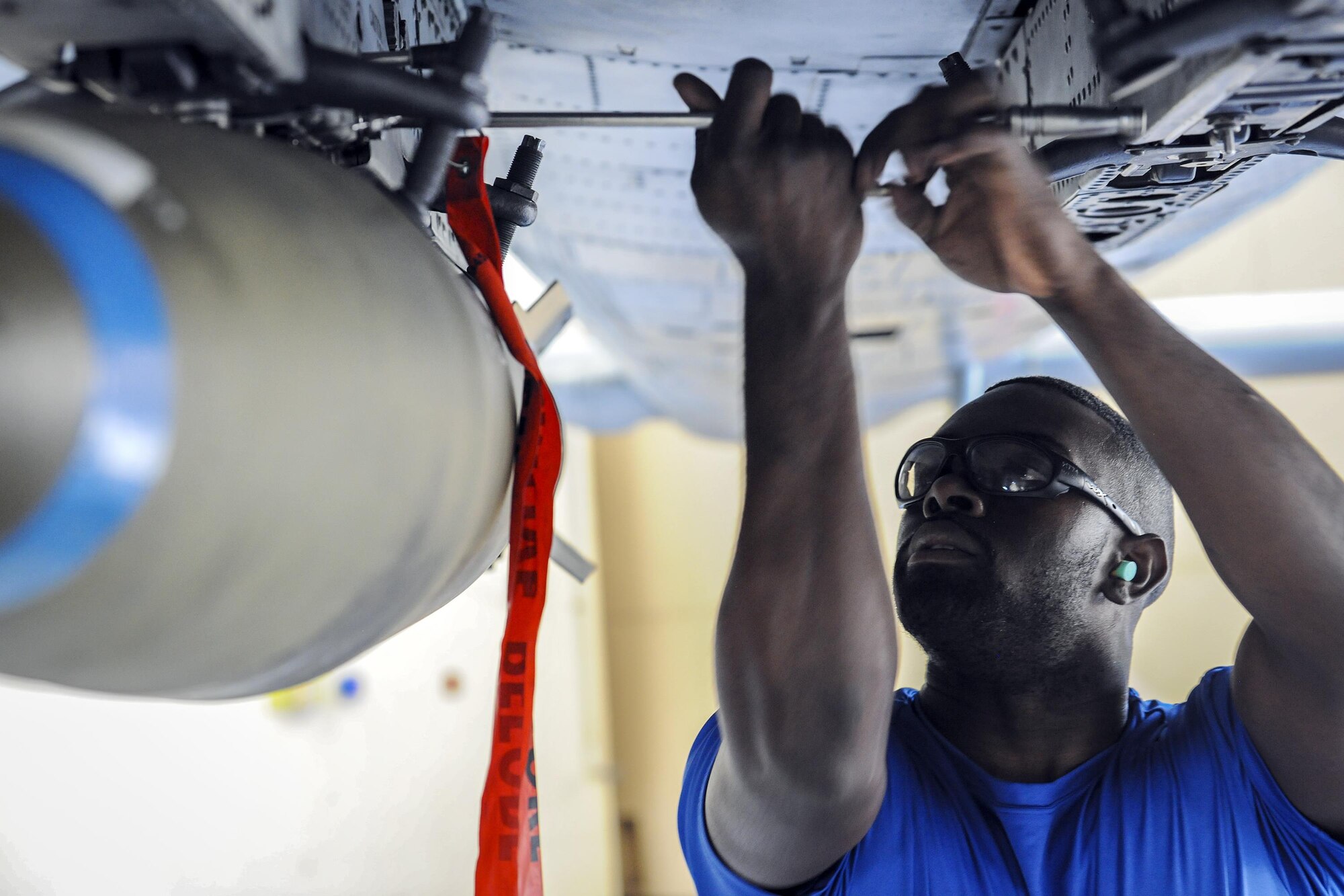 Senior Airman Rodney Brown, 74th Aircraft Maintenance Unit weapons load crew member, tightens a screw during a quarterly weapons load competition, Nov. 16, 2017, at Moody Air Force Base, Ga. Judges evaluated the competitors based on dress and appearance, a knowledge exam and loading various munitions to determine the swiftest and most efficient load crew. (U.S. Air Force photo by Airman Eugene Oliver)