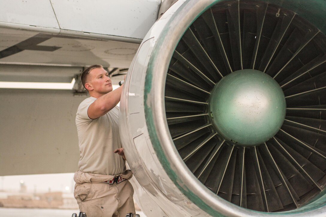 An airman performs post-flight inspections.