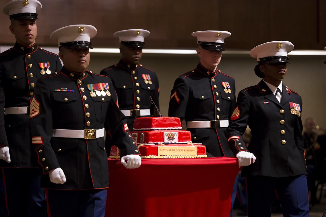 U.S. Marines and Sailors with Headquarters Battalion, Marine Corps Base Hawaii, march the cake during the Battalion's ceremony for the 242nd Marine Corps Birthday Ball, at Hilton Hawaiian Village, Honolulu, Hawaii, Nov. 11, 2017. Each year Marines across the globe celebrate the date on which the Marine Corps was founded and the proud legacy that it's many years of existence has wrought. (U.S. Marine Corps photo by Sgt. Alex Kouns)