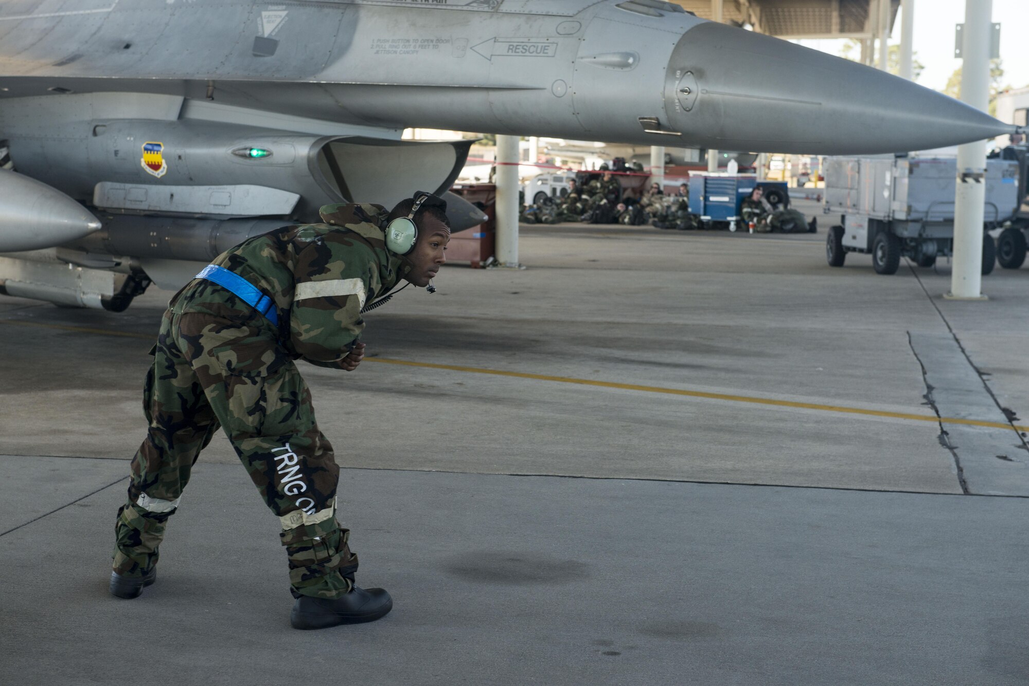 A U.S. Air Force tactical aircraft maintainer assigned to the 20th Aircraft Maintenance Squadron marshals out an F-16CM Fighting Falcon at Shaw Air Force Base, South Carolina, Nov. 16, 2017.