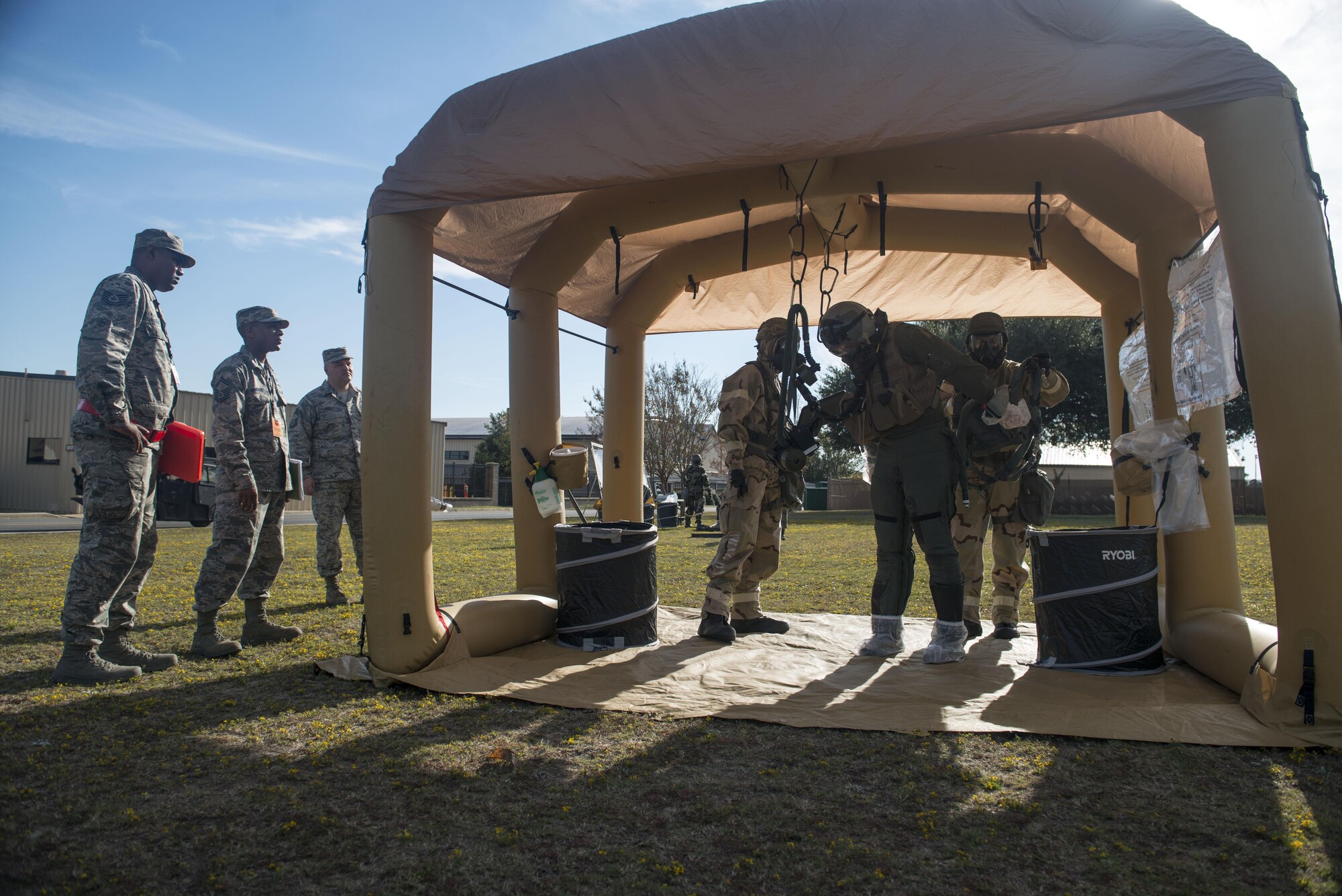 U.S. Airmen simulate decontaminating a pilot while wing inspection team members watch during the first Rapid Ready Weasel at Shaw Air Force Base, South Carolina, Nov. 16, 2017.