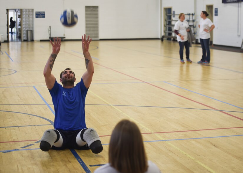 Warrior plays sitting volleyball