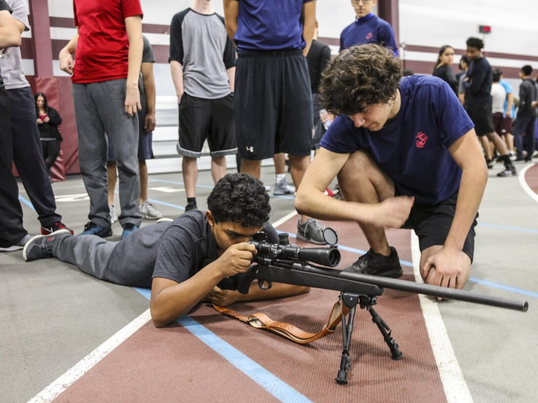 SUMMIT, Ill – Students with Argo Community High School and poolees with Marine Corps Recruiting Sub Station Oak Lawn, Recruiting Station Chicago, familiarize themselves with a Marine Corps weapons system during the Semper Fi Saturday event at Argo Community High School in Summit, Illinois., Nov. 4. Semper Fi Saturday is an event that was created by the Marines of Recruiting Substation Oak Lawn in 2010,  to give high school students appreciation of the Marine Corps by giving them a first-hand experience into how Marines are made. (U.S. Marine Corps photo by Cpl. Quavaungh Pointer)