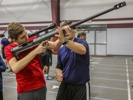 SUMMIT, Ill – Students with Argo Community High School and poolees with Marine Corps Recruiting Sub Station Oak Lawn, Recruiting Station Chicago, familiarize themselves with a Marine Corps weapons system during the Semper Fi Saturday event at Argo Community High School in Summit, Illinois., Nov. 4. Semper Fi Saturday is an event that was created by the Marines of Recruiting Substation Oak Lawn in 2010,  to give high school students appreciation of the Marine Corps by giving them a first-hand experience into how Marines are made. (U.S. Marine Corps photo by Cpl. Quavaungh Pointer)