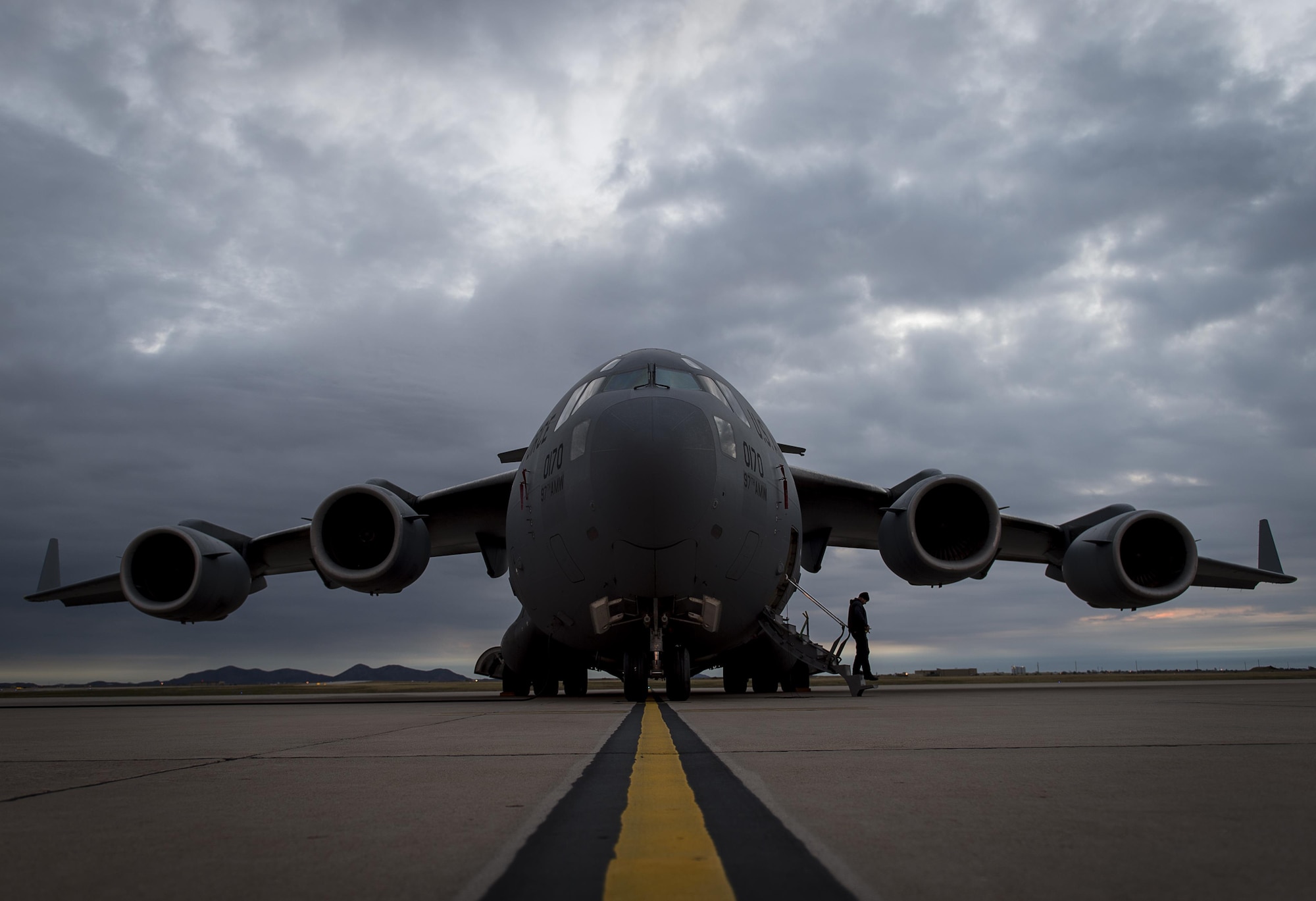An A-Team member with the 97th Maintenance Group exits a C-17 Globemaster III during the Altus Quarterly Exercise (ALTEX), Nov. 16, 2017 at Altus Air Force Base, Okla.