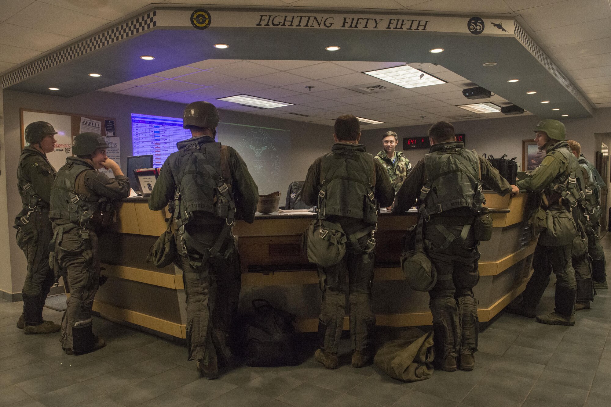 U.S. Air Force pilots assigned to the 55th Fighter Squadron meet for a pre-flight brief at the unit operations desk at Shaw Air Force Base, South Carolina, Nov. 16, 2017.