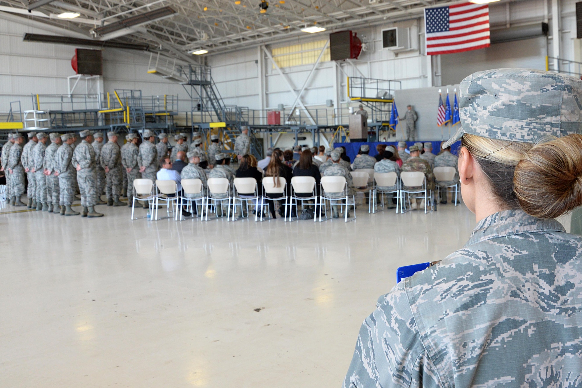 First Lt. Brianna Houston, 81st Training Wing Protocol Office chief of protocol, observes the 22nd Air Force change of command in the isochronal dock Nov. 14, 2017, on Keesler Air Force Base, Mississippi. The Protocol Office is in charge of ensuring every ceremony on Keesler goes to plan according to Air Force standards. (U.S. Air Force photo by Airman 1st Class Suzanna Plotnikov)