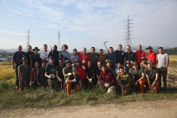 Republic of Korea Marines with ROK Marine Logistics Group and U.S. Marines with Combat Logistics Regiment 3, 3rd MLG, gather together before harvesting rice during a community service project, Oct. 27, 2017 in Pohang, South Korea. The ROK Marines and U.S. Marines helped local rice farmers harvest crops from fields damaged by Super Typhoon Lan during Exercise Winter Workhorse 17/ Korea Marine Exchange Program 18.1. The individual Marines and Sailors’ relationships with their ROK counterparts and is the strength of III MEF in the Pacific. (U.S. Marine Corps photo by Sgt. Tiffany Edwards)